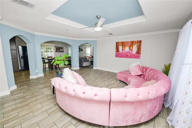 a kitchen with stainless steel appliances a stove a sink a kitchen island a table and chairs