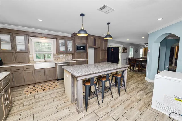 a kitchen with granite countertop stainless steel appliances and wooden cabinets