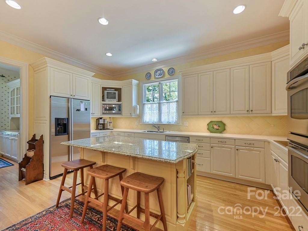 2236 Overhill Road Charlotte, NC 28211 - Photo 11 of 48 a kitchen with stainless steel appliances granite countertop a sink and a refrigerator
