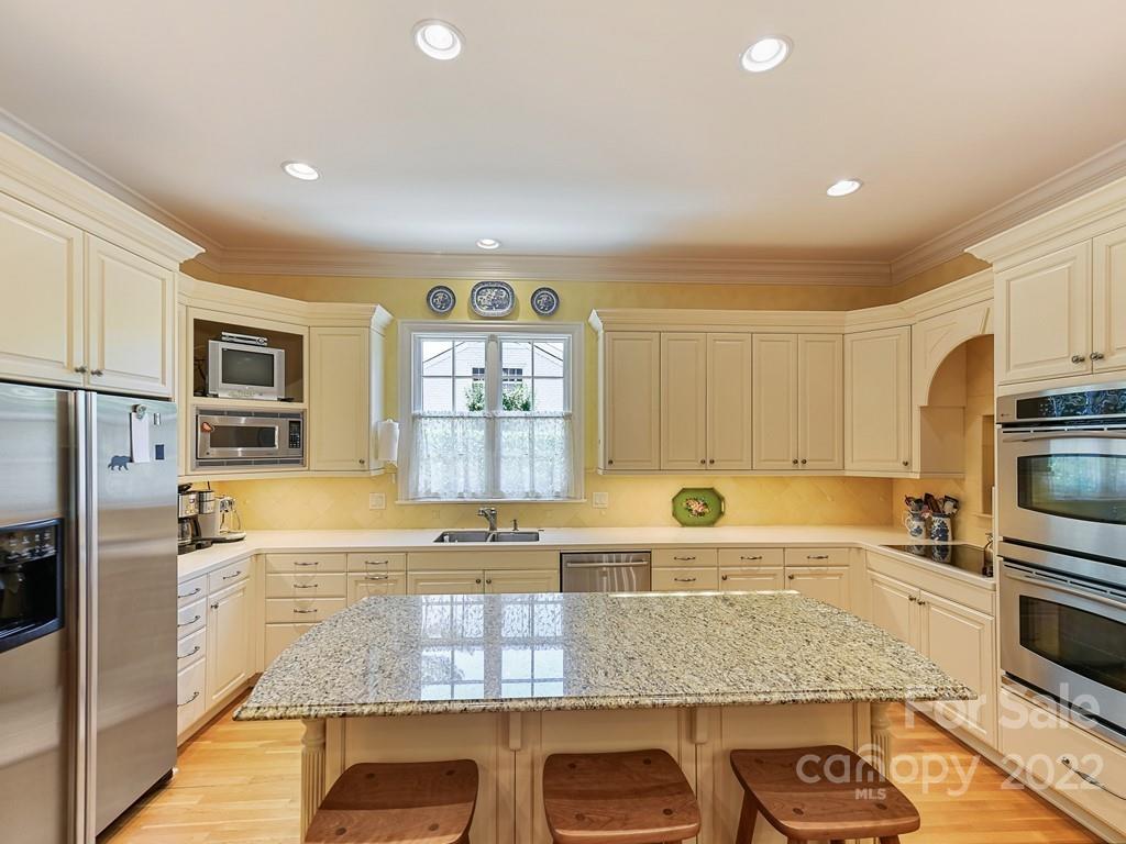 2236 Overhill Road Charlotte, NC 28211 - Photo 12 of 48 a kitchen with stainless steel appliances granite countertop a stove a sink and a microwave