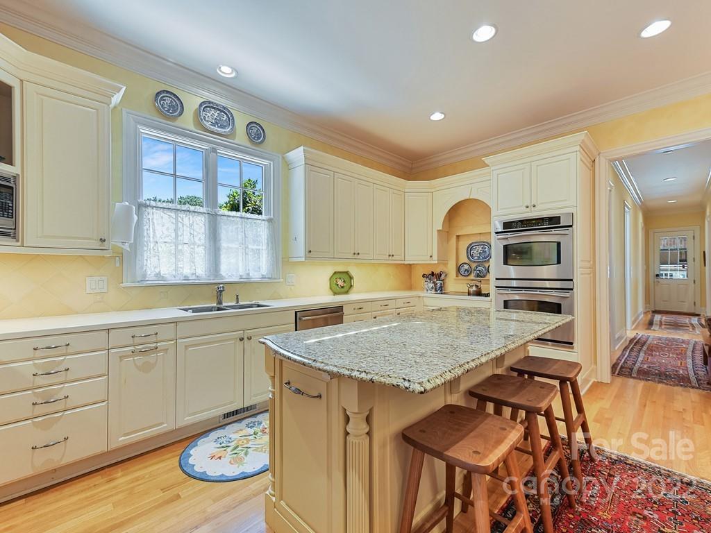 2236 Overhill Road Charlotte, NC 28211 - Photo 13 of 48 a kitchen with a sink stove and cabinets