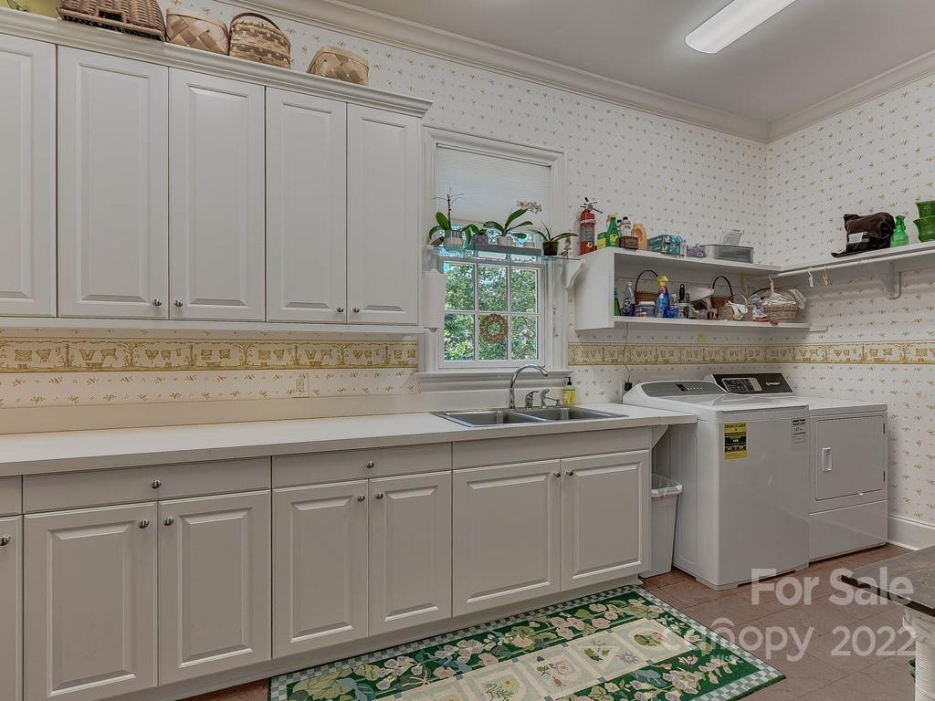 2236 Overhill Road Charlotte, NC 28211 - Photo 28 of 48 a kitchen with white cabinets and sink