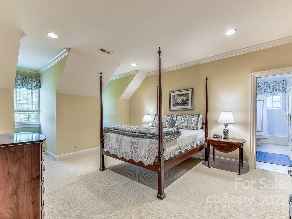 2236 Overhill Road Charlotte, NC 28211 - Photo 30 of 48 a bedroom with a bed and a lamp
