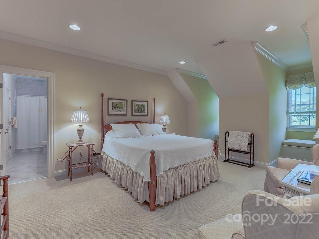 2236 Overhill Road Charlotte, NC 28211 - Photo 32 of 48 a bedroom with a bed and a lamp