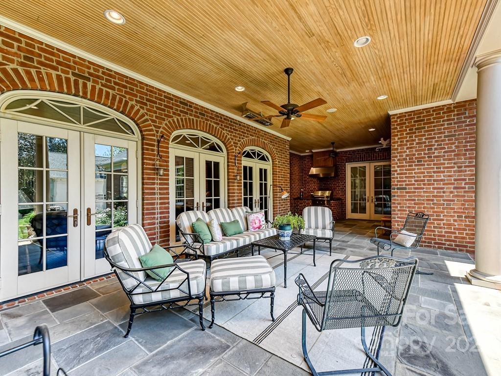 2236 Overhill Road Charlotte, NC 28211 - Photo 36 of 48 a view of a patio with a dining table and chairs