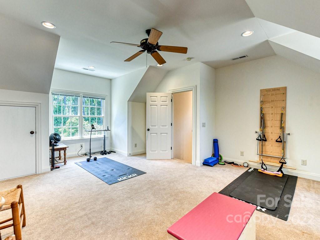 2236 Overhill Road Charlotte, NC 28211 - Photo 41 of 48 a bedroom with a bed and a chandelier