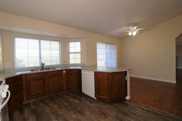 a large kitchen with wooden floors and wooden cabinets
