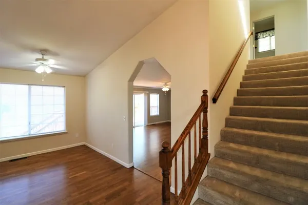a view of an entryway with wooden floor and stairs