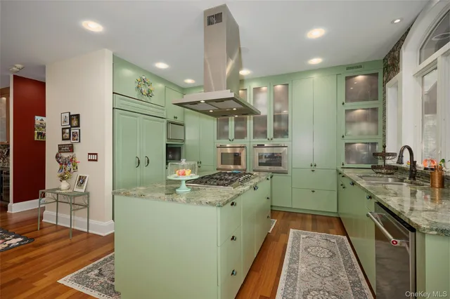 a kitchen with sink a stove and chairs