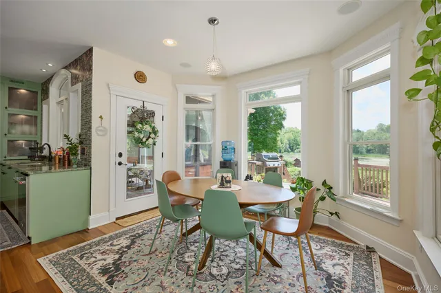 a view of a dining room with furniture window and wooden floor