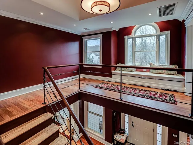 a view of a hallway with furniture and window