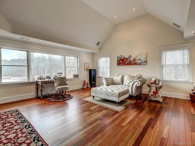 a living room with furniture gym equipment and a large window