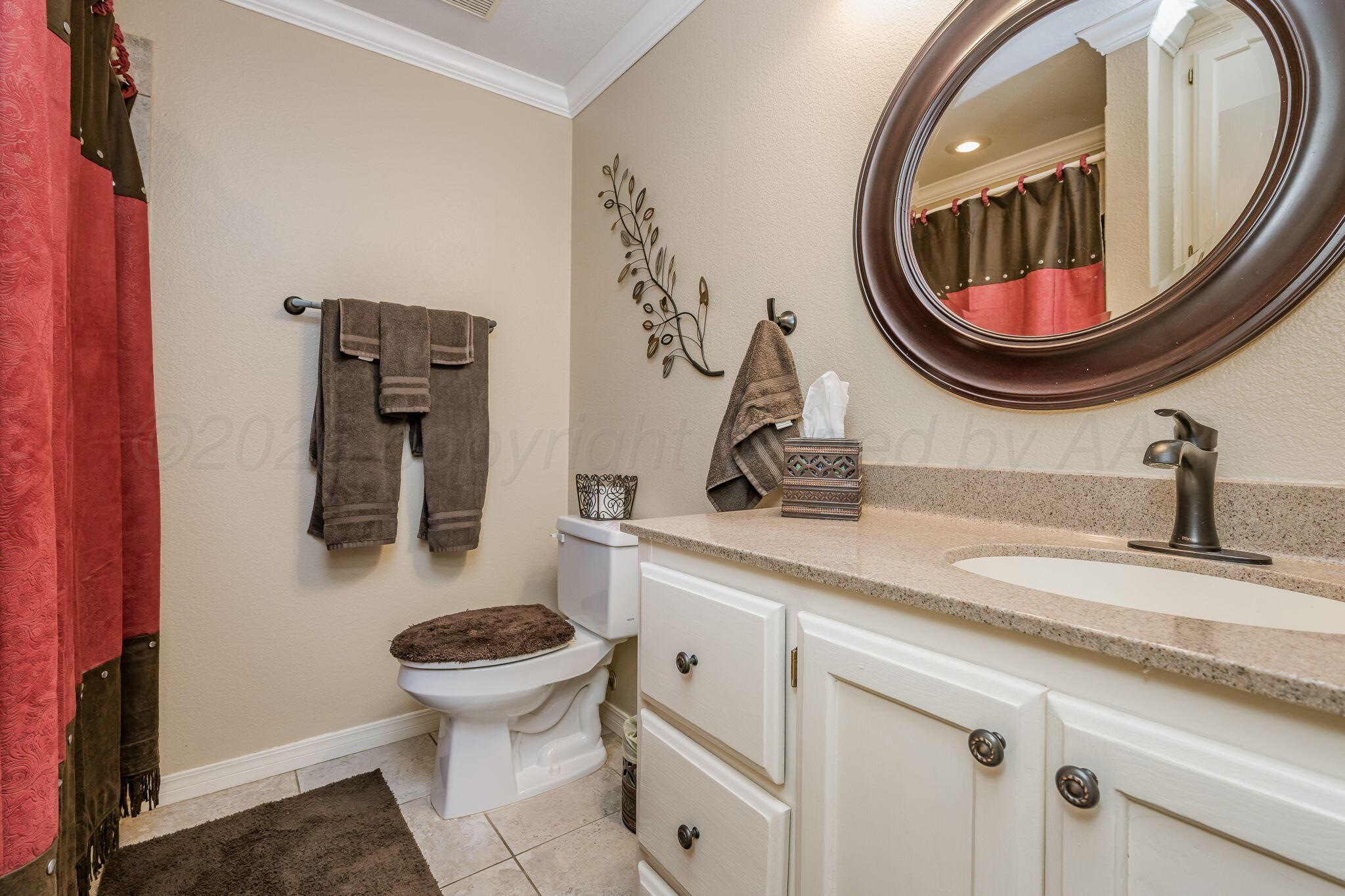 15812 Outback Trail Amarillo, TX 79118 - Photo 20 of 25 a bathroom with a toilet and a mirror