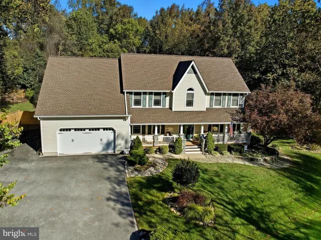 a aerial view of a house with a yard table and chairs