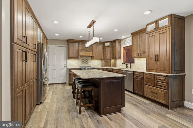 a kitchen with stainless steel appliances granite countertop stove microwave and refrigerator