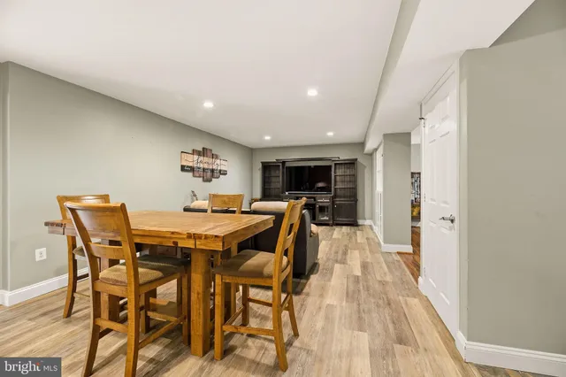 a living room with furniture a wooden floor and a large window