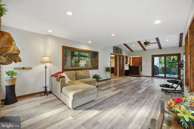 a view of a workspace with furniture and a bookshelf