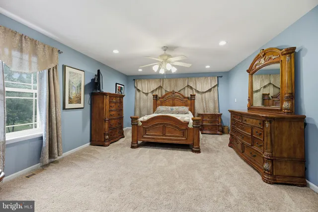 a spacious bathroom with a granite countertop tub and a large window