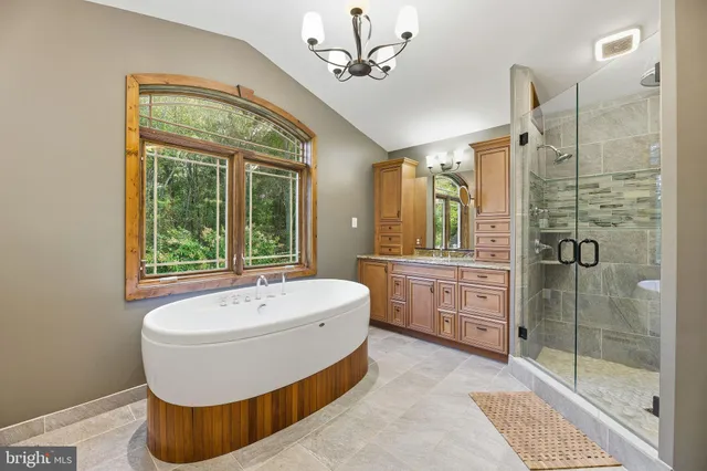a bathroom with a granite countertop sink mirror vanity and toilet