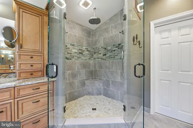 a bathroom with a glass shower door