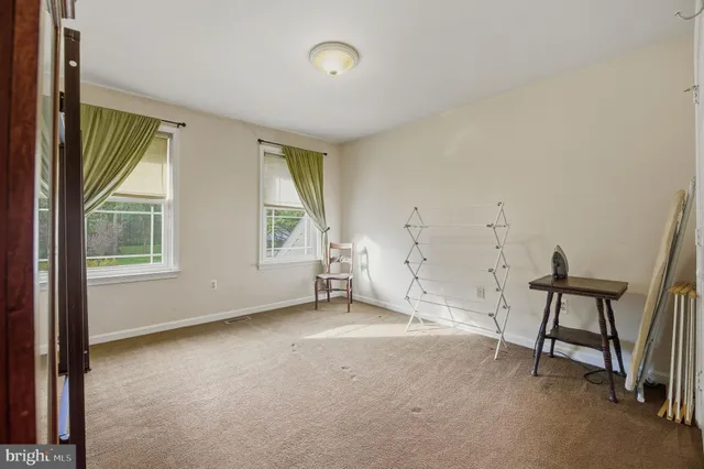 a spacious bathroom with a granite countertop sink and a mirror
