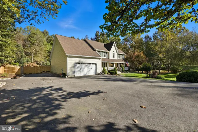 a front view of a house with a yard fountain
