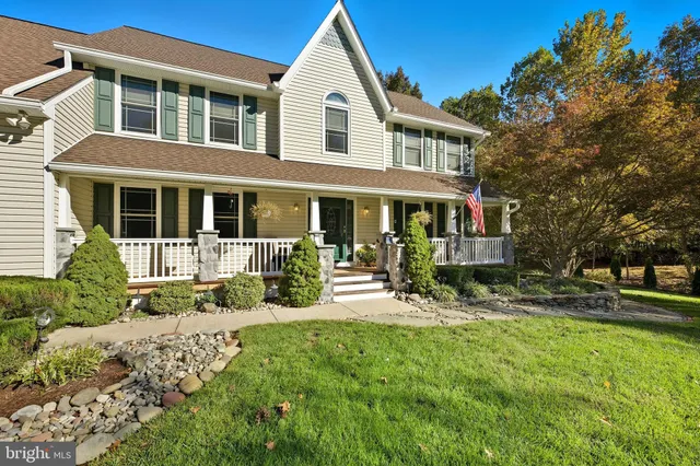 a kitchen with kitchen island granite countertop wooden floors granite top and stainless steel appliances