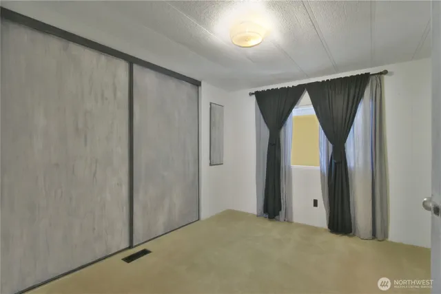 a view of a room that has a large window and bathroom view