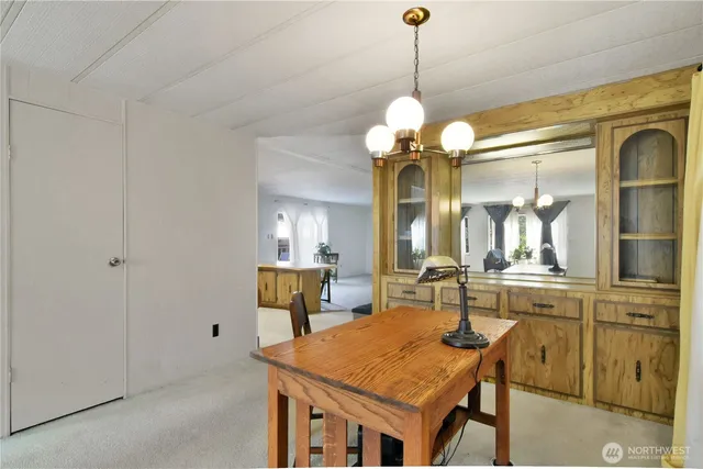 a view of a dining room with furniture and a chandelier