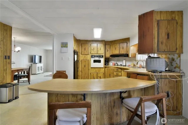 a kitchen with a table and chairs in it