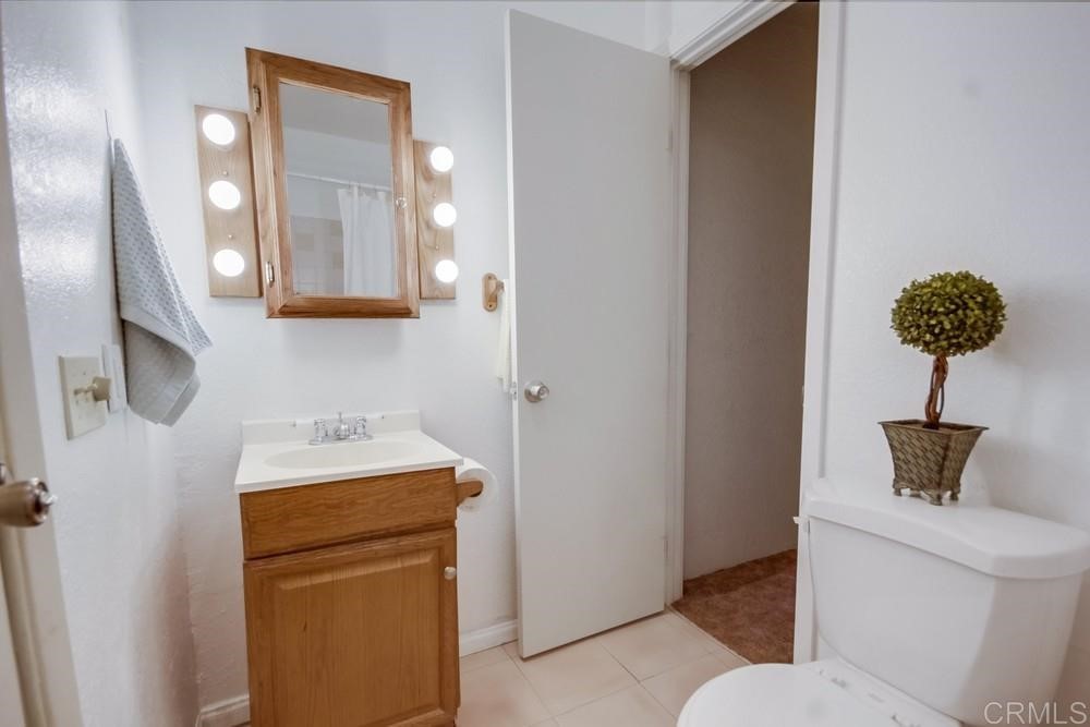 9913 Lindo Lane Lakeside, CA 92040 - Photo 18 of 53 a bathroom with a toilet sink and mirror