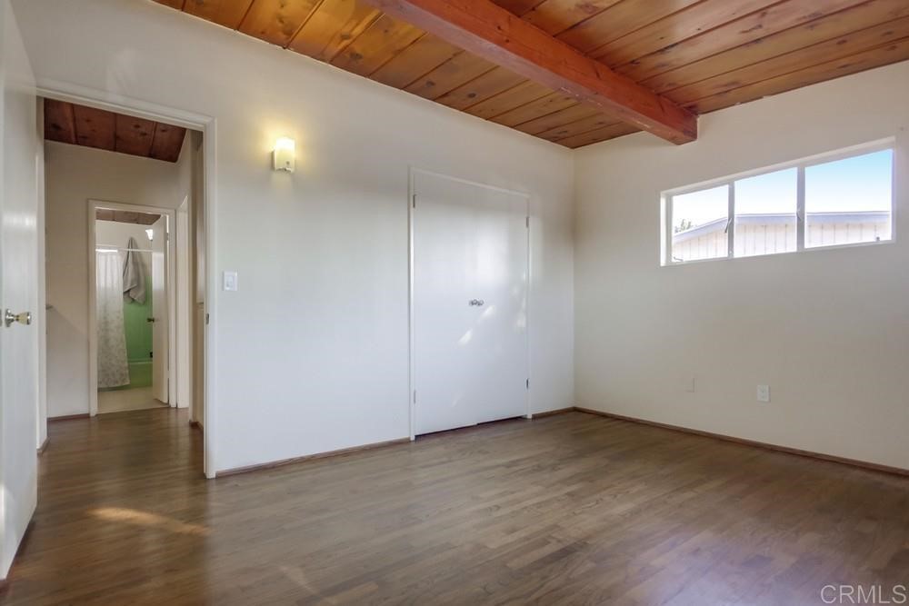 9913 Lindo Lane Lakeside, CA 92040 - Photo 20 of 53 an empty room with wooden floor and windows
