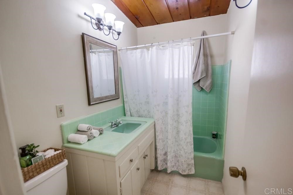 9913 Lindo Lane Lakeside, CA 92040 - Photo 23 of 53 a bathroom with a granite countertop sink a mirror and shower