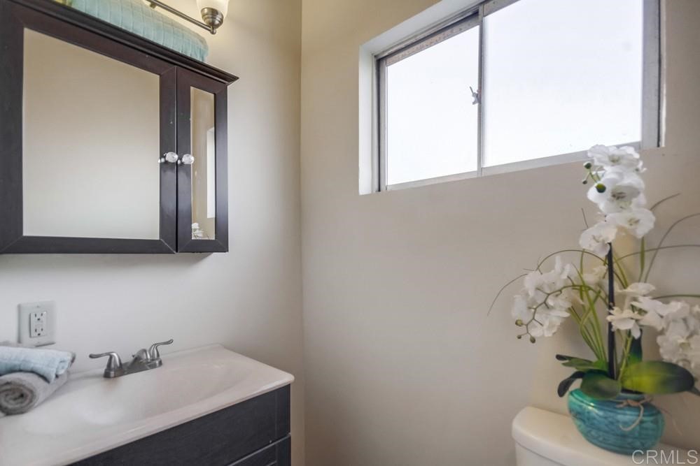 9913 Lindo Lane Lakeside, CA 92040 - Photo 27 of 53 a bathroom with a sink a toilet and a mirror