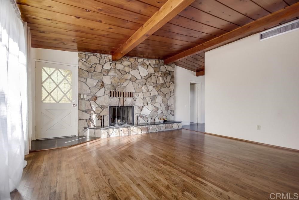 9913 Lindo Lane Lakeside, CA 92040 - Photo 32 of 53 a view of an empty room with wooden floor and a window