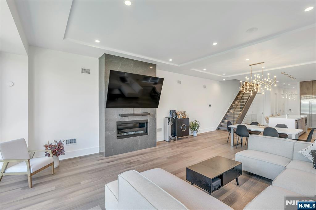 1238 River Road Edgewater, NJ 07020 - Photo 12 of 45 a living room with furniture and a flat screen tv