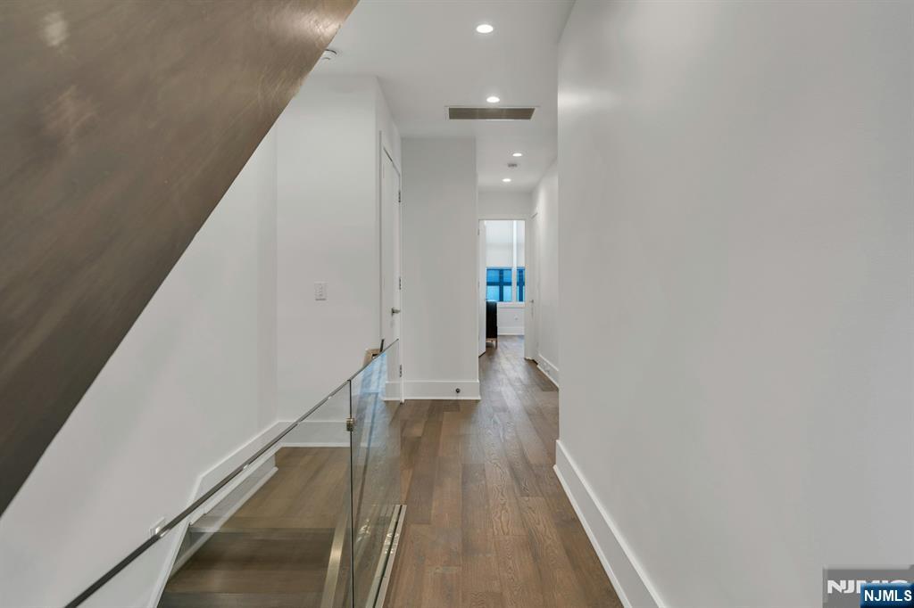 1238 River Road Edgewater, NJ 07020 - Photo 13 of 45 a view of a hallway with wooden floor and staircase