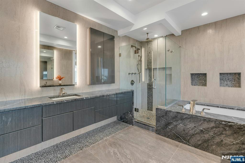 1238 River Road Edgewater, NJ 07020 - Photo 17 of 45 a bathroom with double vanity sinks and a shower