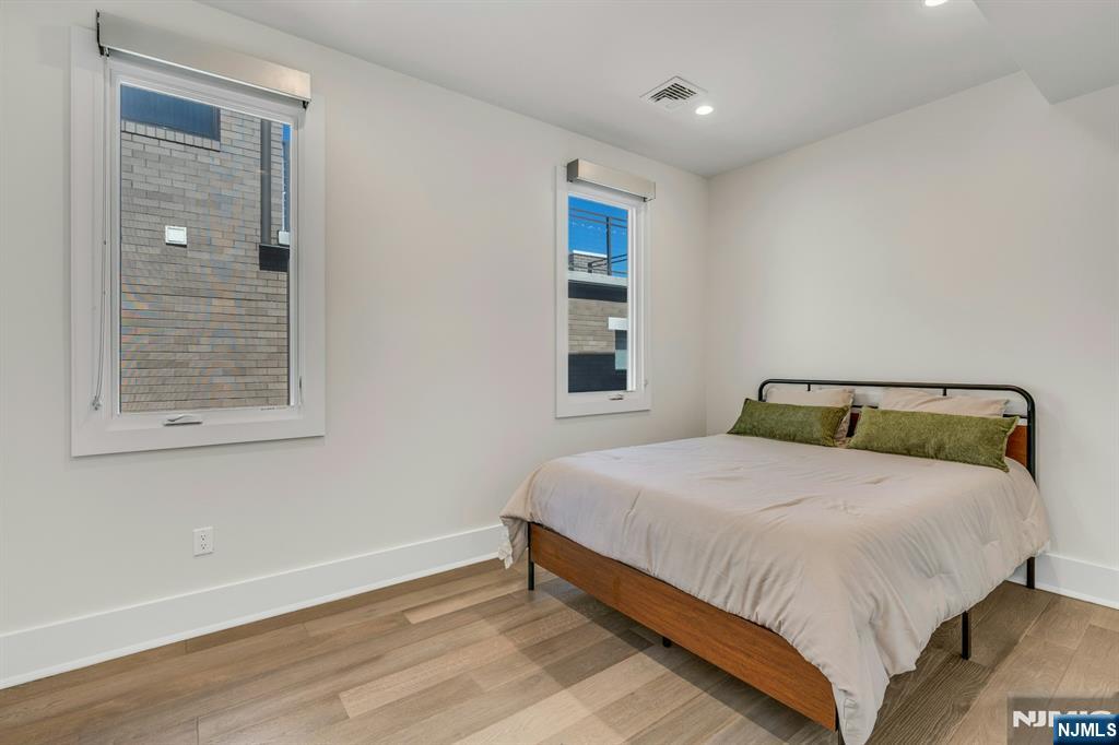 1238 River Road Edgewater, NJ 07020 - Photo 19 of 45 a bedroom with a bed and window