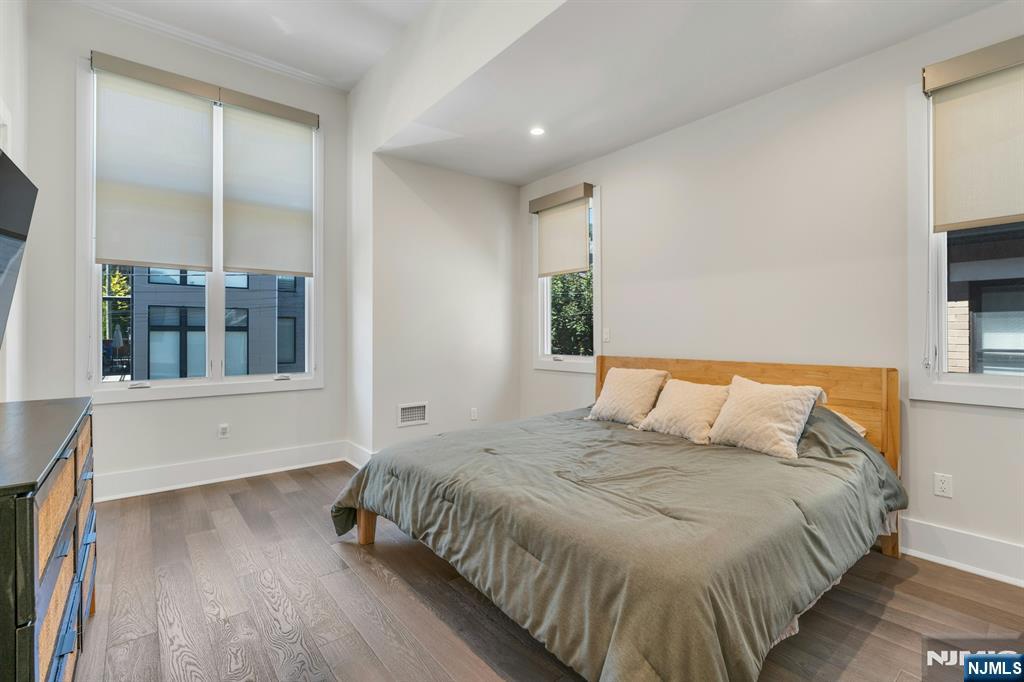 1238 River Road Edgewater, NJ 07020 - Photo 21 of 45 a large bed sitting in a bedroom next to a window