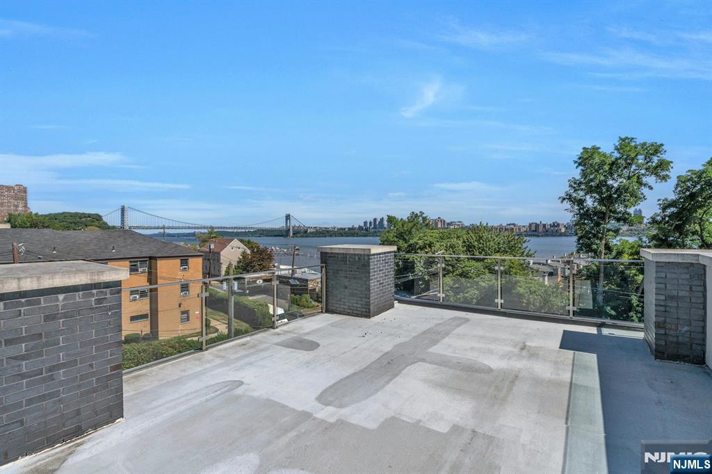 1238 River Road Edgewater, NJ 07020 - Photo 25 of 45 a view of a terrace with a garden