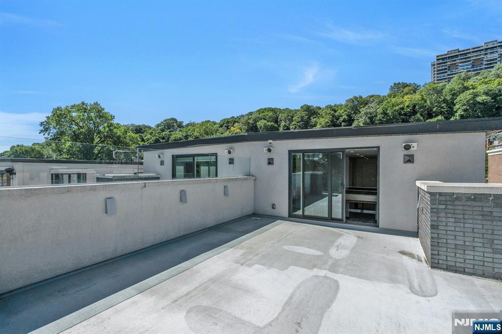 1238 River Road Edgewater, NJ 07020 - Photo 28 of 45 a front view of a house with a garden