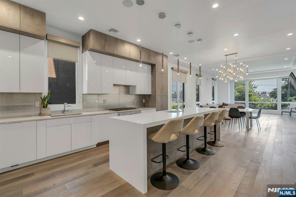 1238 River Road Edgewater, NJ 07020 - Photo 3 of 45 a large kitchen with lots of counter space and view of living room