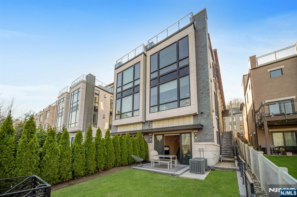 1238 River Road Edgewater, NJ 07020 - Photo 42 of 45 a view of a building with a yard and sitting area