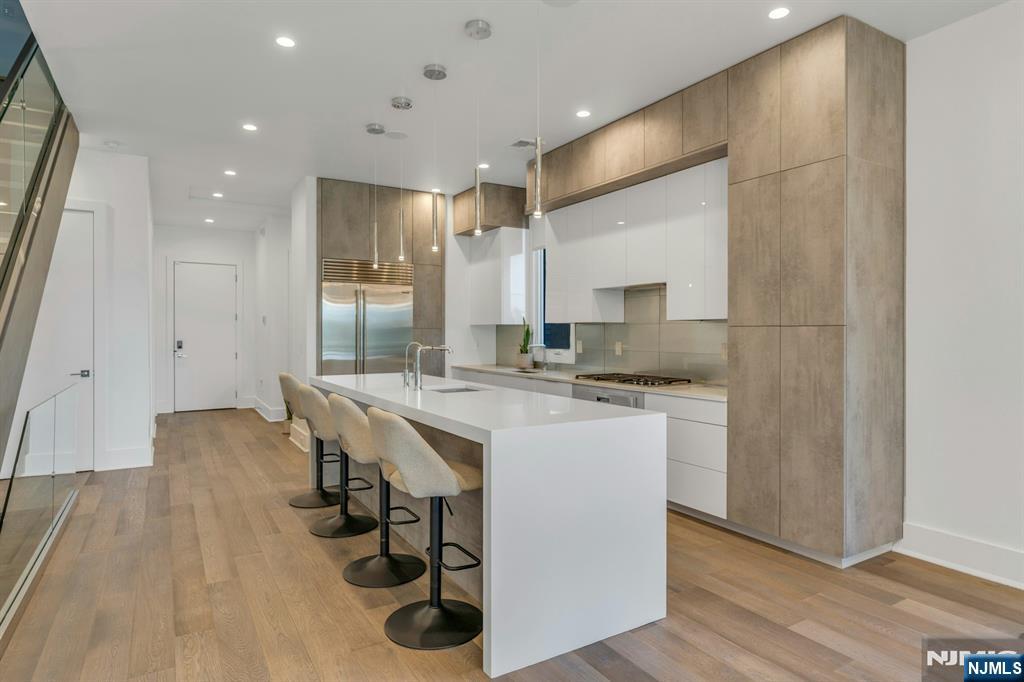 1238 River Road Edgewater, NJ 07020 - Photo 5 of 45 a kitchen with a sink cabinets and wooden floor