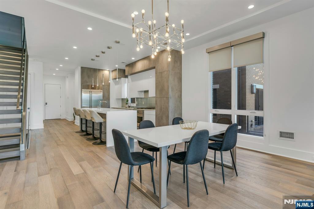 1238 River Road Edgewater, NJ 07020 - Photo 6 of 45 a view of a dining room with furniture and wooden floor