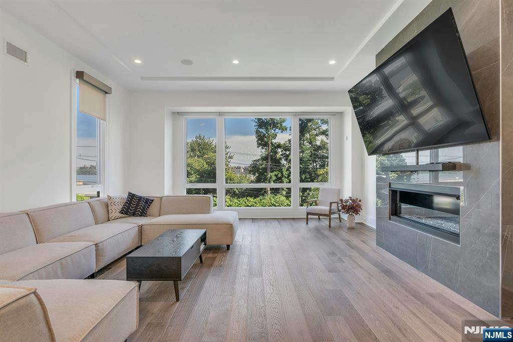 1238 River Road Edgewater, NJ 07020 - Photo 8 of 45 a living room with furniture and a fireplace