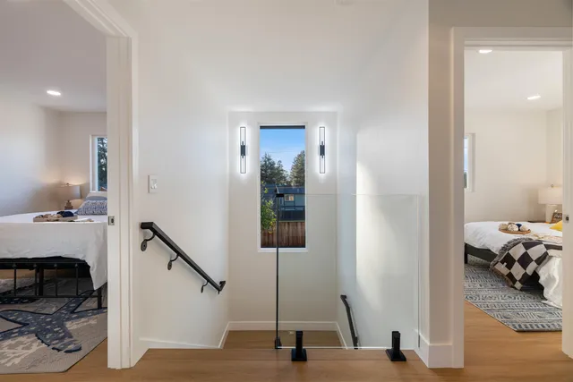 a bed sitting in a bedroom next to a window
