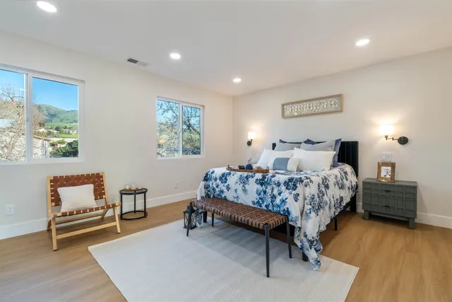 an aerial view of residential houses with outdoor space and parking