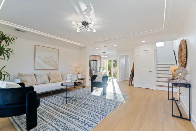a living room with furniture and a chandelier